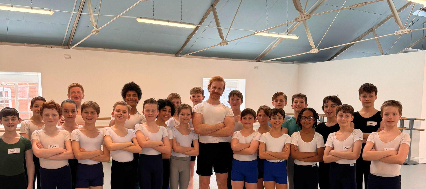 steven McRae, Principal Dancer at the royal Ballet with a Group of male dancers dressed in dancewear from Boys Do Ballet 