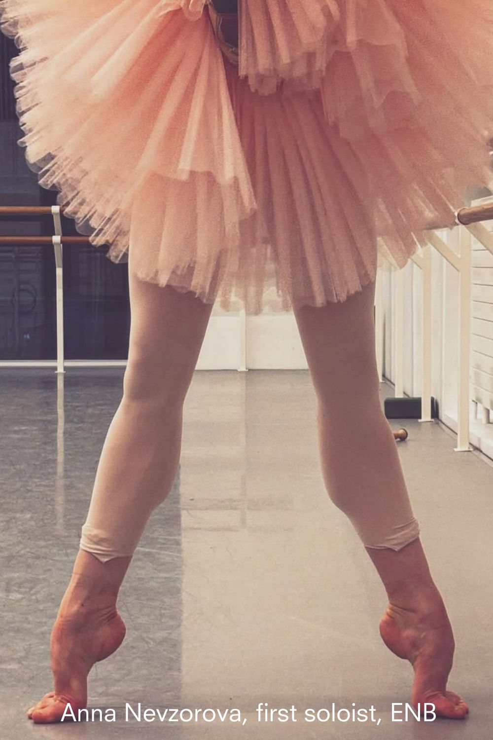 Anna Nevzorova, first soloist Ballerina at English National ballet shown from waist down in a tutu and tights standing in a ballet studio wearing imperfect pointes tights