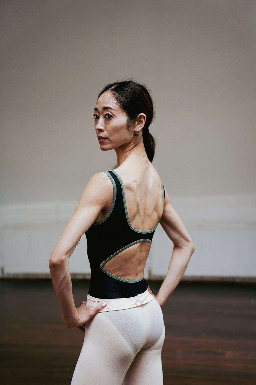 Koto Ishihara, Principal Dancer, National Ballet of Canada wearing seychelles cut out leotard in black and army trim