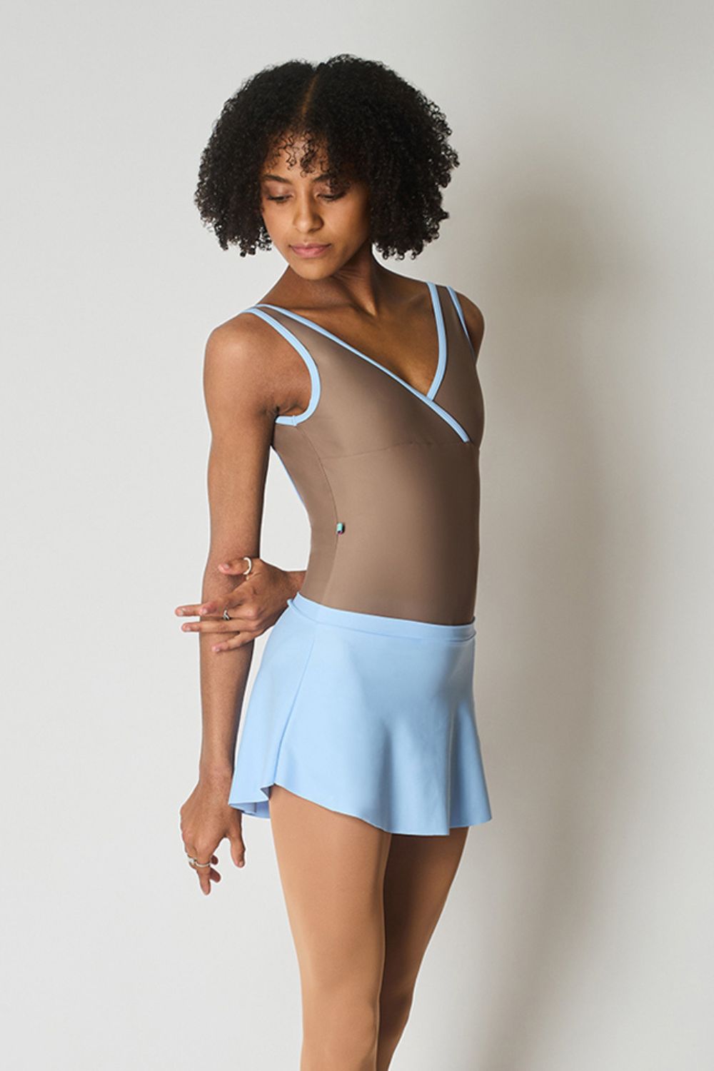 brown ballerina wearing Imperfect Pointes Marseille ballet leotard in Mocha brown with SAB ballet skirt in pastel blue