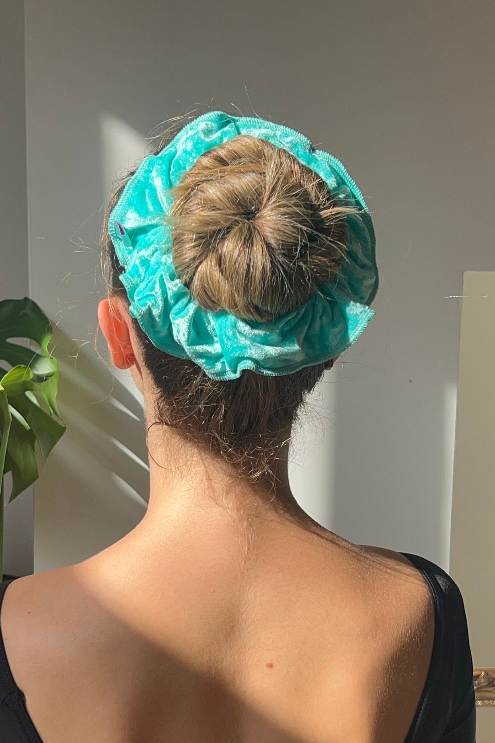 ballerina wearing crushed velvet hair scrunchie in mint green colour.