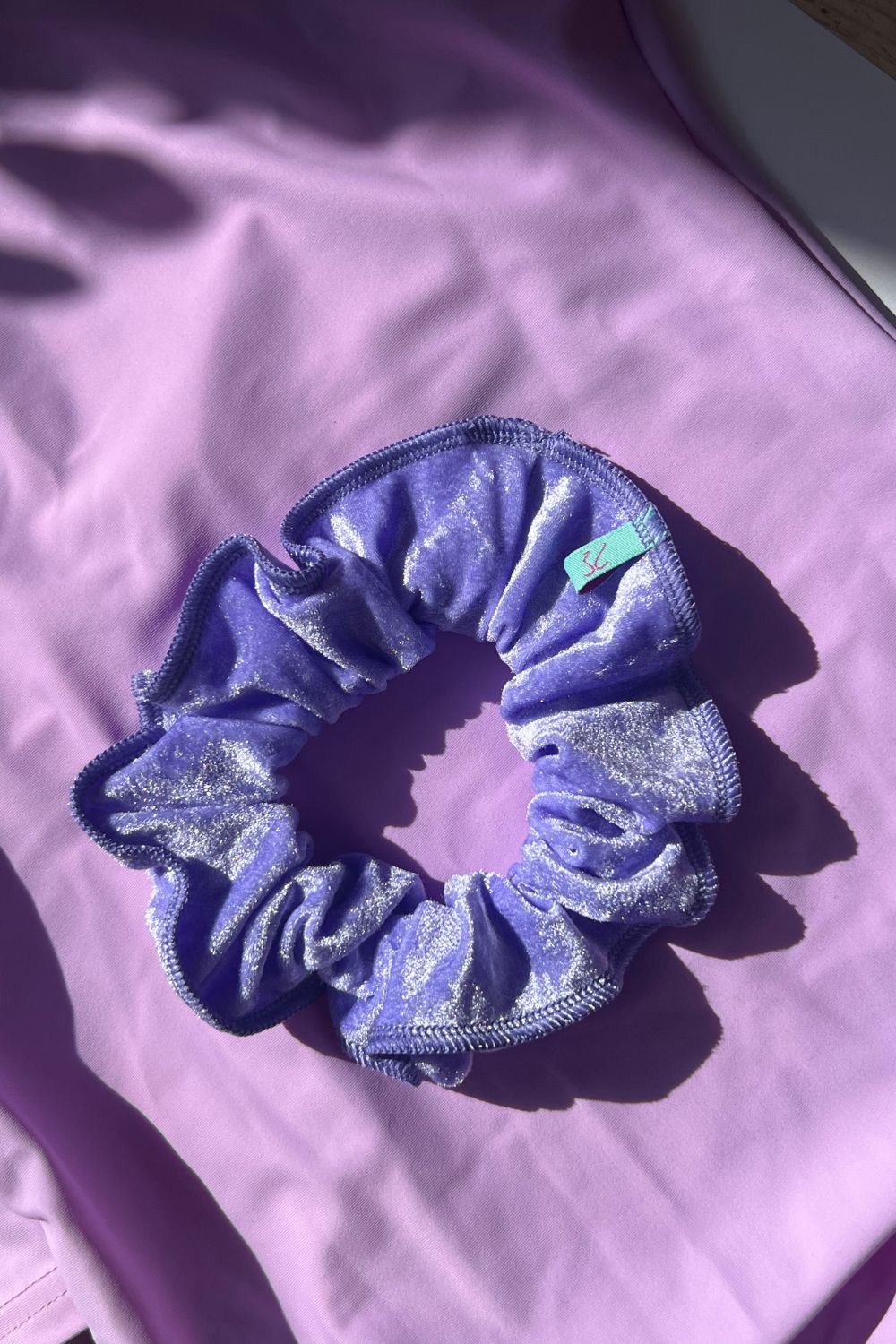 crushed velvet hair scrunchie in light purple colour. 