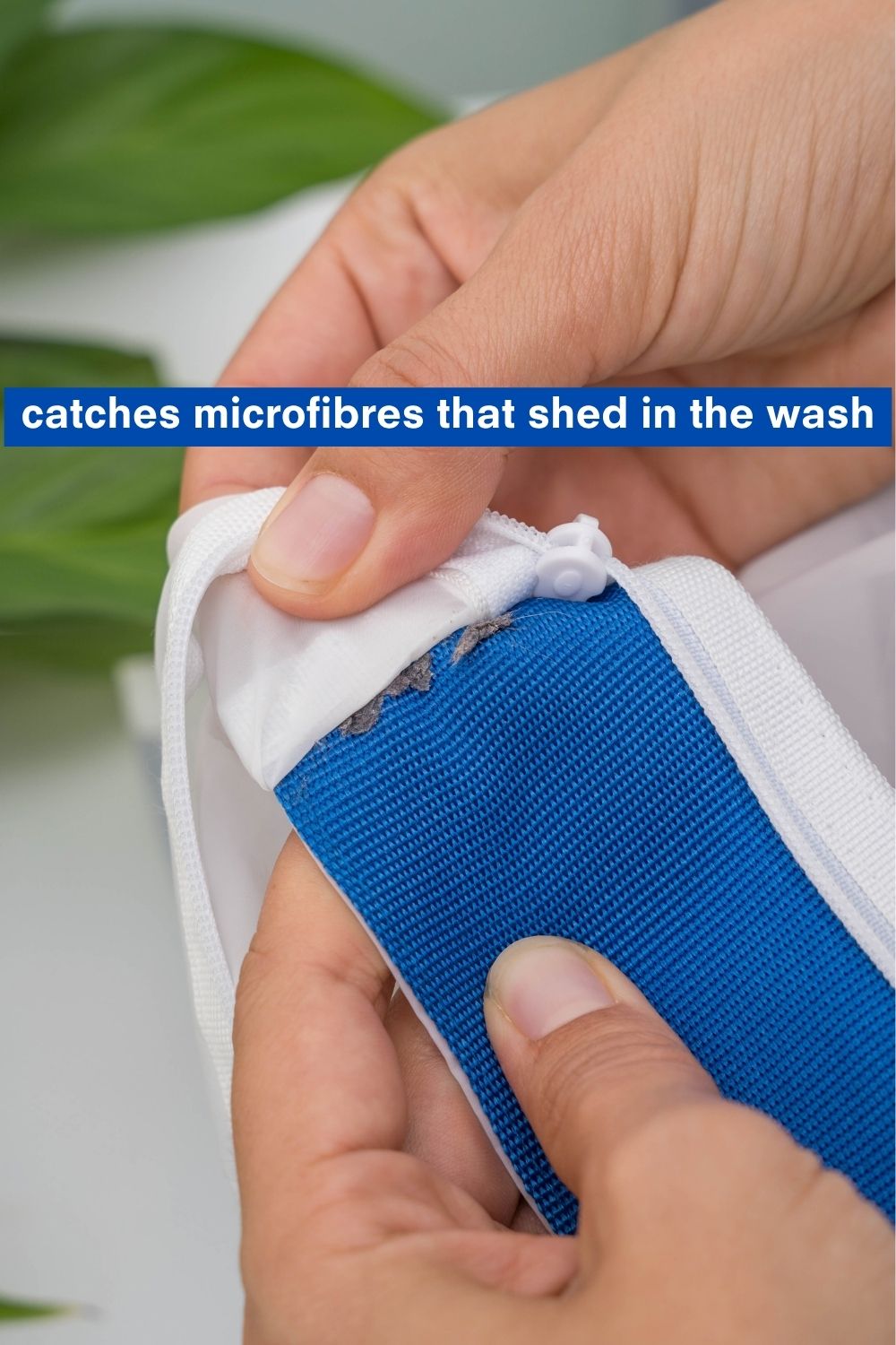 Close-up of collected fibres in a GUPPYFRIEND washing bag seam, with text “catches microfibres that shed in the wash”.