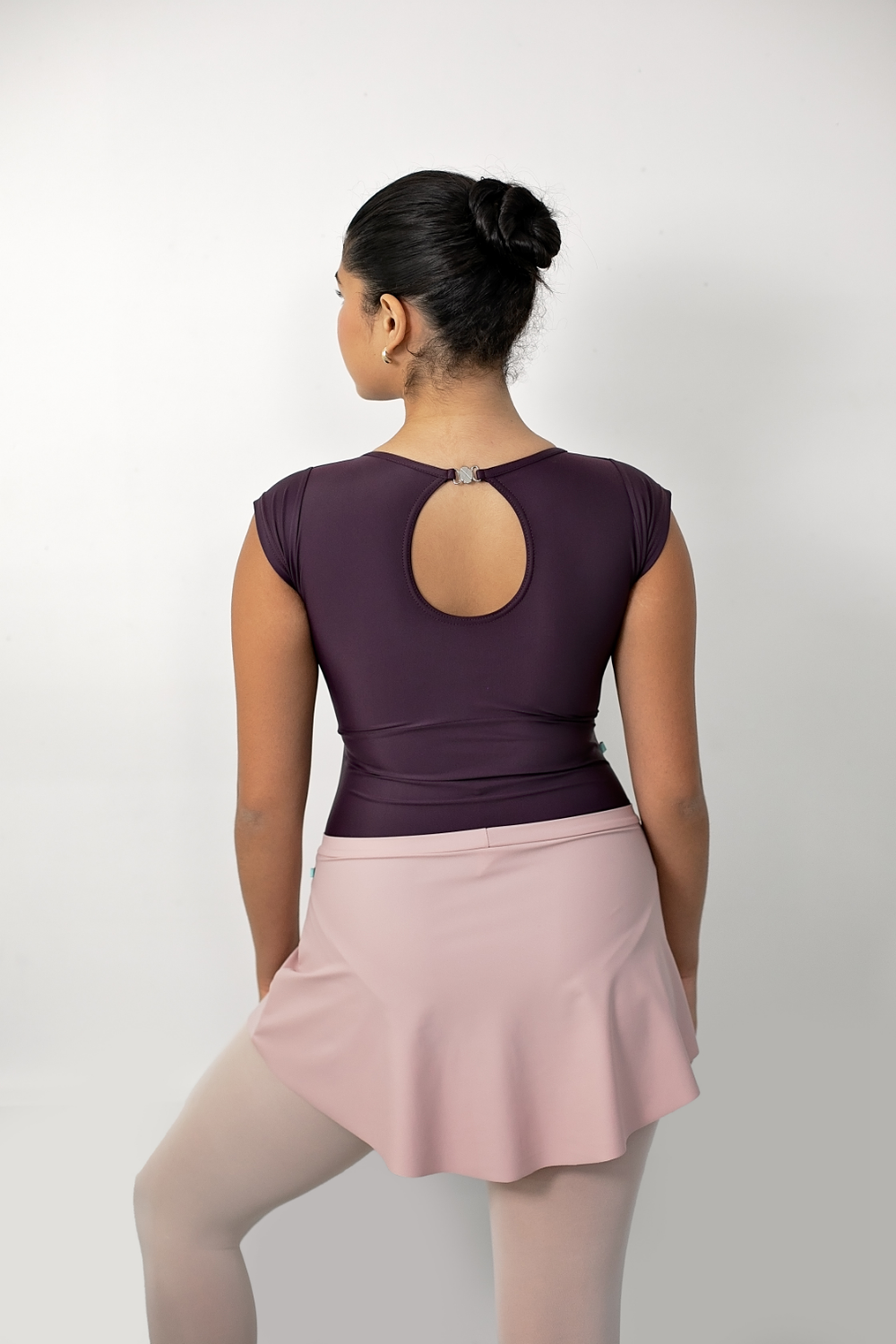 dancer in the studio showing the back view of a blush pink SAB ballet skirt 