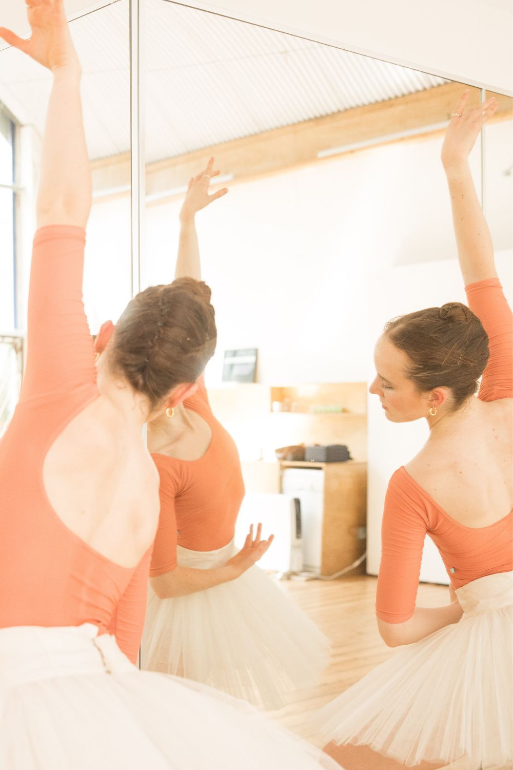 ballerina in a white tutu with imperfect pointes barcelona leotard in porcelain peach