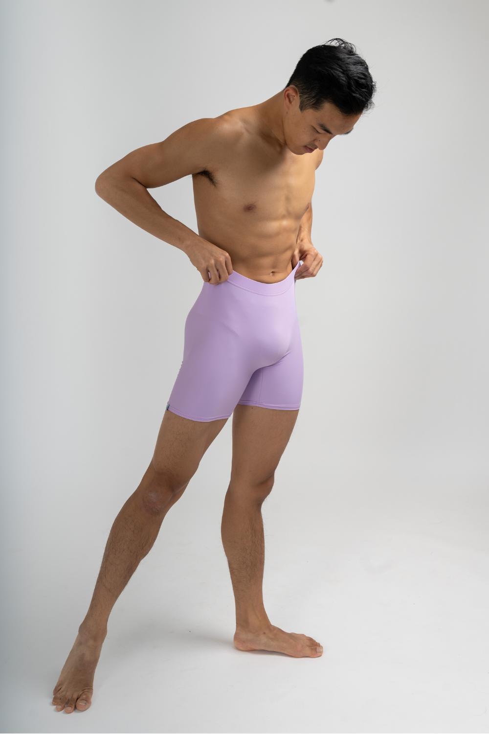 mens dance shorts in a lavender colourway. shows male ballet dancer posing in shorts 