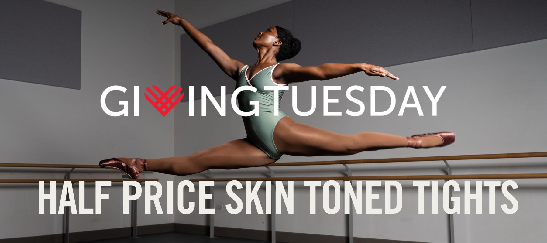 brown ballet dancer jumping in the the studio wearing brown skin toned sustainable ballet tights and pointe shoes for giving Tuesday 